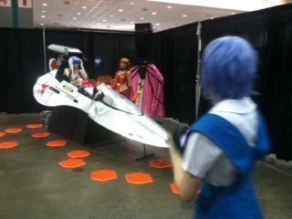 An Evangelion cockpit used as a backdrop for cosplay photography.